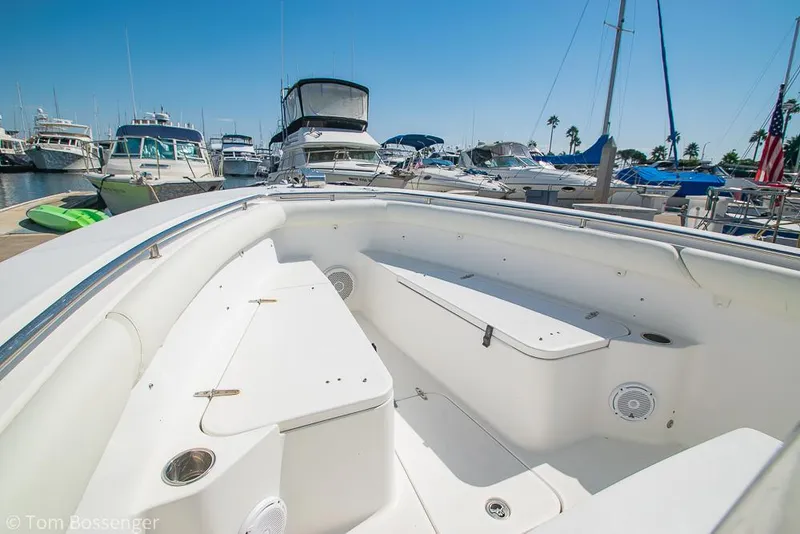 Slide: The Image of 2010 Sea Hunt Gamefish 29 boat interior at marina, surrounded by various docked boats. - 17