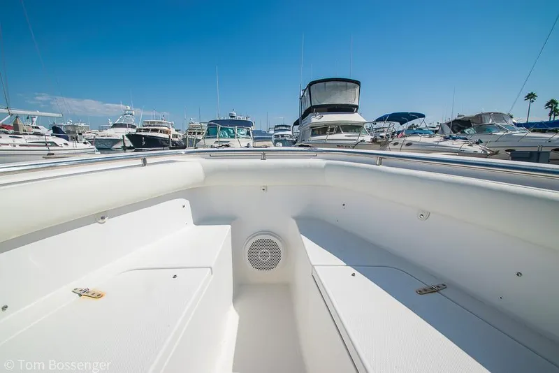 Slide: The Image of Bow view of 2010 Sea Hunt Gamefish 29 in a marina, surrounded by various boats. - 18