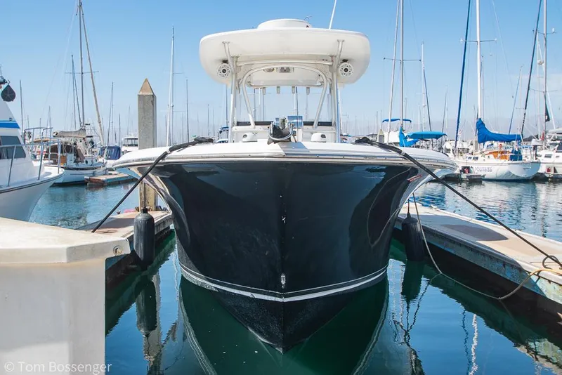 Slide: The Image of 2010 Sea Hunt Gamefish 29 boat docked in a marina, front view. - 2