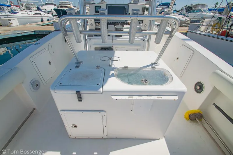 Slide: The Image of 2010 Sea Hunt Gamefish 29 boat deck with fishing rod holders and storage compartments. - 25