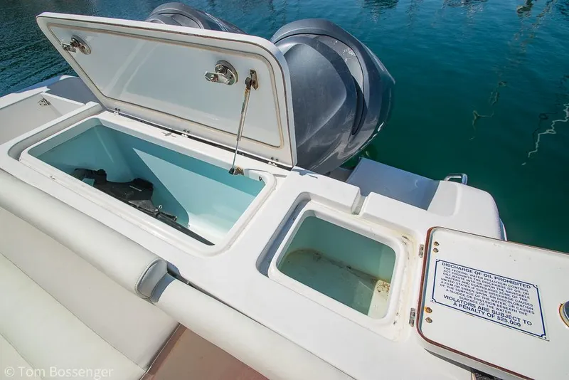 Slide: The Image of 2010 Sea Hunt Gamefish 29 boat with open storage compartments and dual engines. - 28