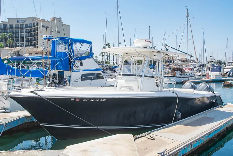 Slide: The Image of 2010 Sea Hunt Gamefish 29 boat docked at marina with other vessels in background. - 3