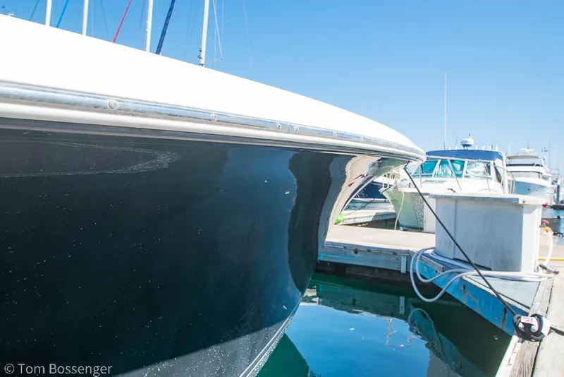 Slide: The Image of 2010 Sea Hunt Gamefish 29 docked at marina under clear blue sky. - 34