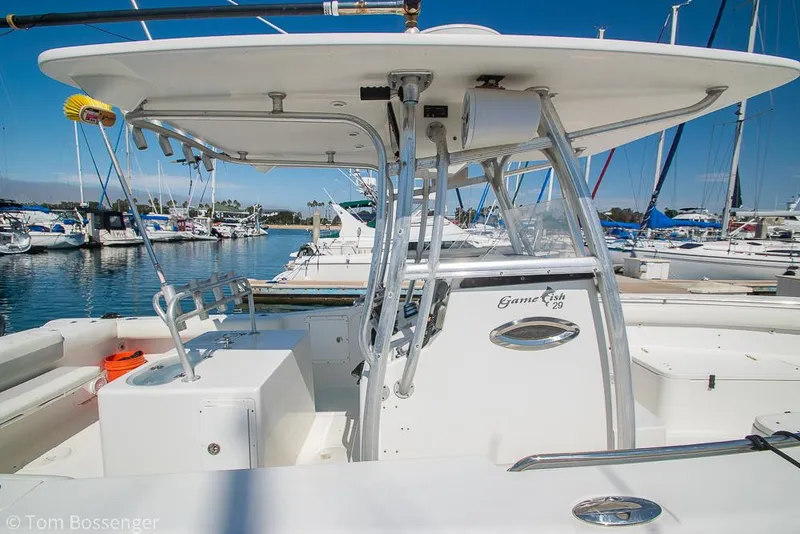 Slide: The Image of 2010 Sea Hunt Gamefish 29 boat docked at marina, featuring sleek design and spacious deck. - 5