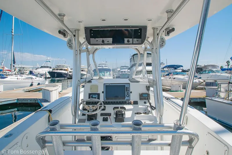Slide: The Image of 2010 Sea Hunt Gamefish 29 boat dashboard with navigation equipment, docked at a marina. - 6