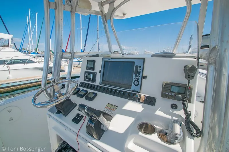 Slide: The Image of Control panel of a 2010 Sea Hunt Gamefish 29 boat, featuring navigation equipment and steering wheel. - 7