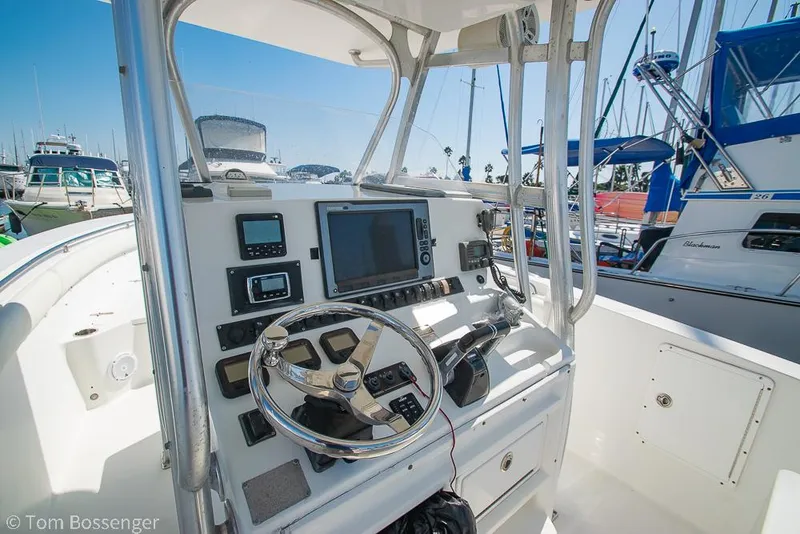 Slide: The Image of 2010 Sea Hunt Gamefish 29 boat console with navigation equipment and steering wheel. - 8