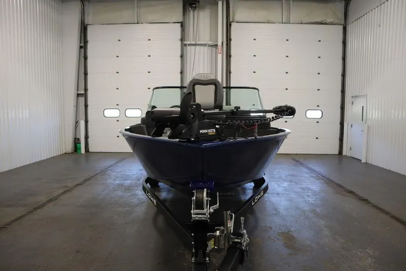 Slide: The Image of 2025 Lowe 1775 FM WT boat in a garage, front view. - 1