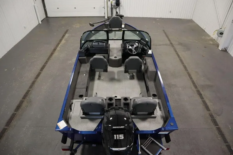 Slide: The Image of 2025 Lowe 1775 FM WT boat interior with Mercury 115 engine, in a garage setting. - 10