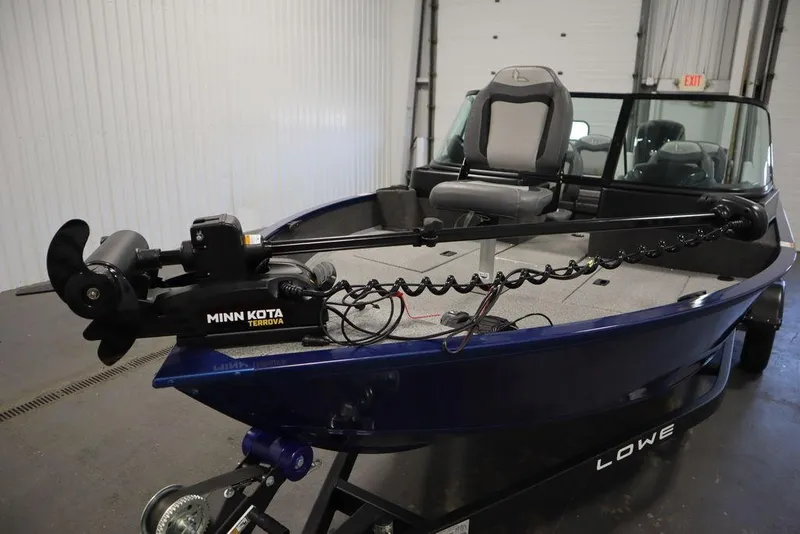 Slide: The Image of 2025 Lowe 1775 FM WT boat with Minn Kota Terrova motor in a garage setting. - 12
