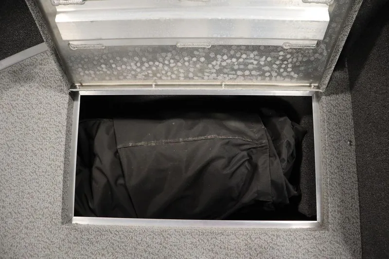 Slide: The Image of Open storage compartment in 2025 Lowe 1775 FM WT boat, containing a black bag. - 17
