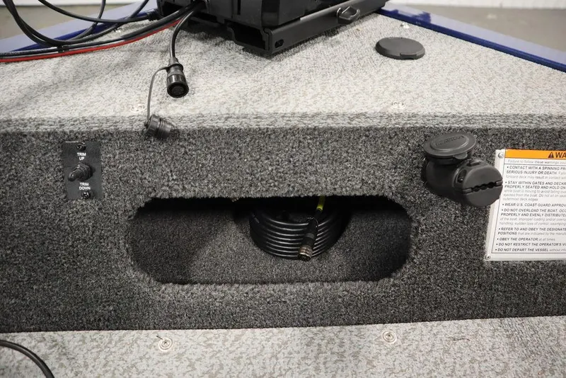 Slide: The Image of 2025 Lowe 1775 FM WT boat interior with trim controls and wiring details. - 18