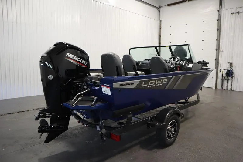Slide: The Image of 2025 Lowe 1775 FM WT fishing boat with Mercury outboard motor in a garage setting. - 2