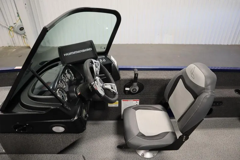 Slide: The Image of 2025 Lowe 1775 FM WT boat interior with steering console and seat. - 24
