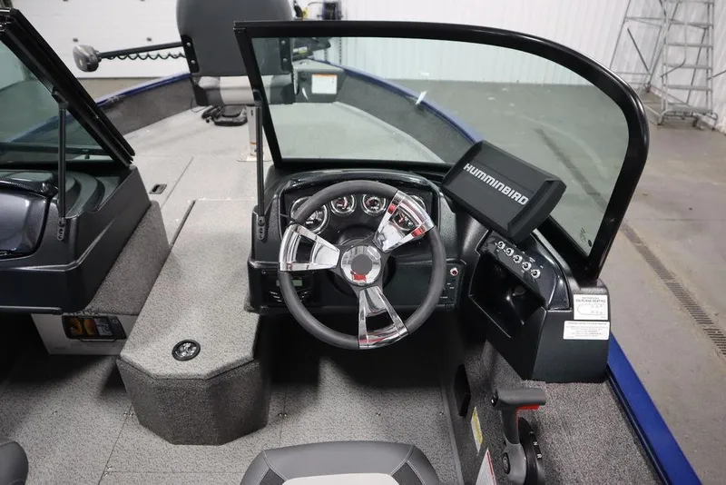 Slide: The Image of 2025 Lowe 1775 FM WT boat interior with steering wheel and Humminbird display. - 27