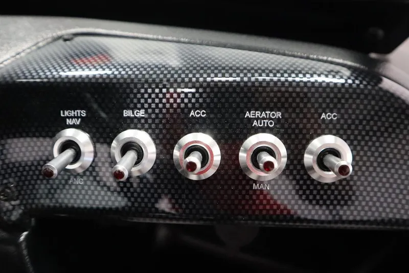 Slide: The Image of Control panel of 2025 Lowe 1775 FM WT boat with toggle switches for lights, bilge, and accessories. - 29