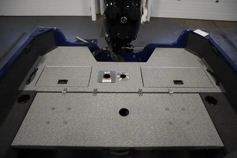 Slide: The Image of 2025 Lowe 1775 FM WT boat interior with storage compartments and motor. - 40