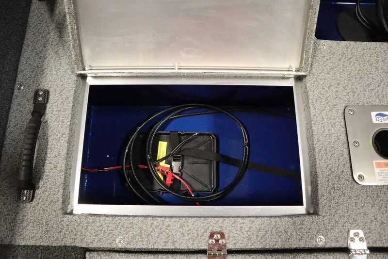 Slide: The Image of Open storage compartment in 2025 Lowe 1775 FM WT boat, showing wiring and battery. - 41