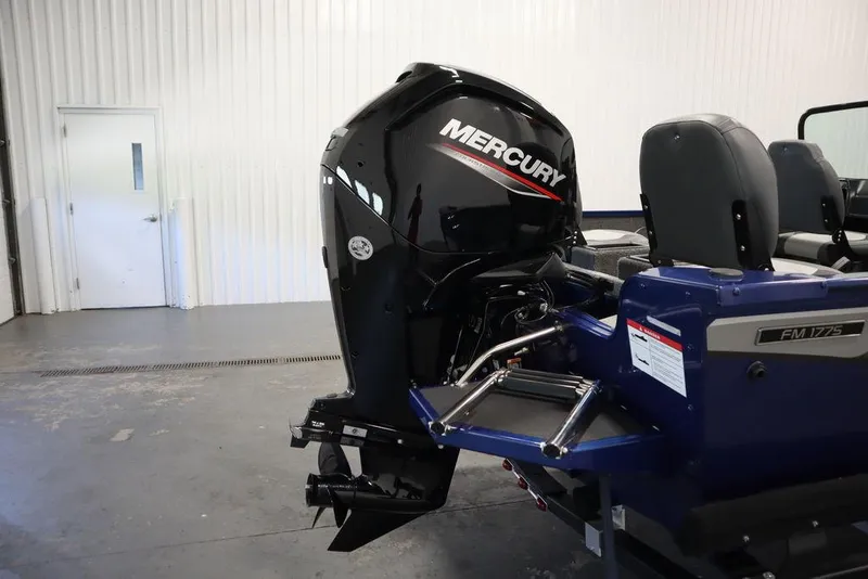 Slide: The Image of 2025 Lowe 1775 FM WT boat with Mercury outboard motor in a garage setting. - 45