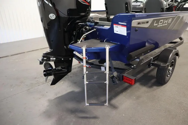 Slide: The Image of 2025 Lowe 1775 FM WT boat with motor and trailer, featuring a blue exterior. - 46