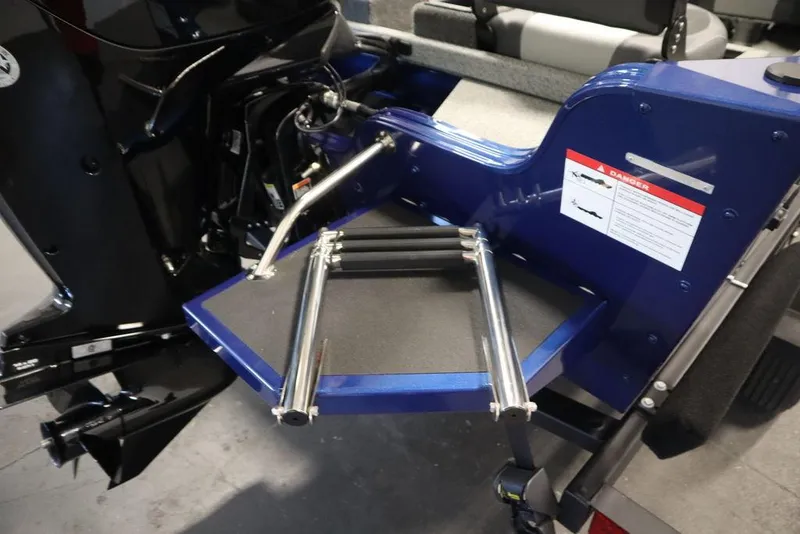 Slide: The Image of 2025 Lowe 1775 FM WT boat with a foldable ladder and safety warning label. - 47