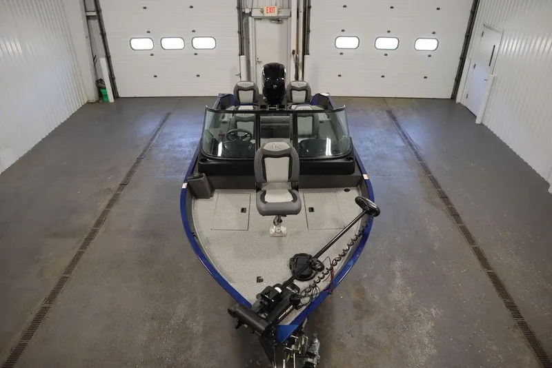 Slide: The Image of 2025 Lowe 1775 FM WT boat in a garage, featuring a sleek design and modern equipment. - 5