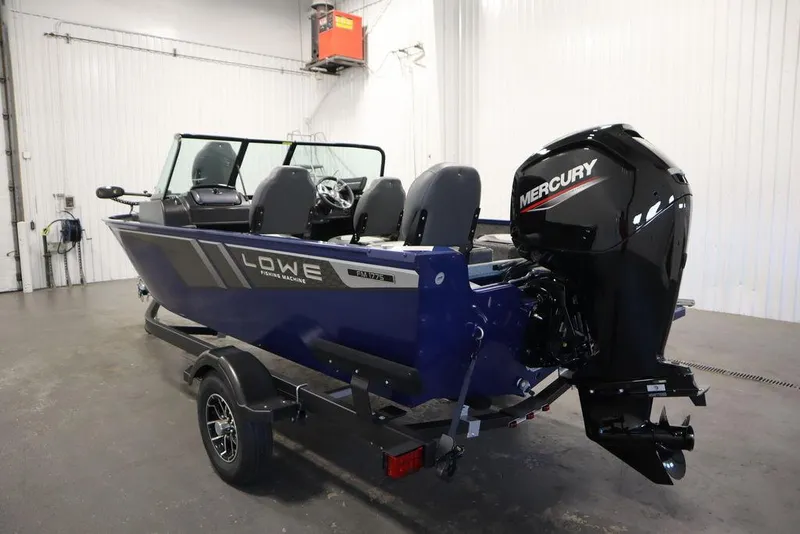 Slide: The Image of 2025 Lowe 1775 FM WT fishing boat with Mercury engine in a garage setting. - 6