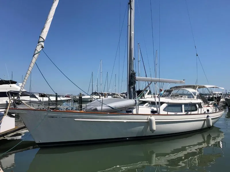 The Image of Fantasi 44 Pilot House 2003 sailboat docked in marina under clear blue sky. - 1