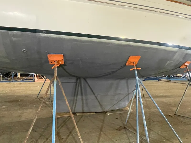 Slide: The Image of Fantasi 44 Pilot House 2003 sailboat hull supported by stands in a boatyard. - 11