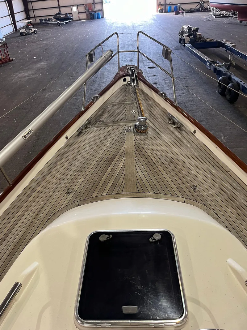 Slide: The Image of 2003 Fantasi 44 Pilot House yacht in storage, showcasing deck and bow details. - 14