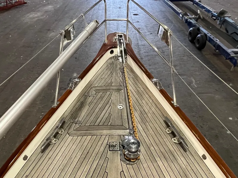 Slide: The Image of Bow view of 2003 Fantasi 44 Pilot House sailboat with wooden deck and anchor chain. - 15