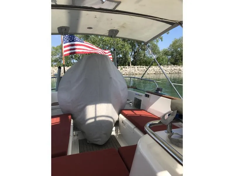 Slide: The Image of 2003 Fantasi 44 Pilot House boat interior with covered equipment and American flag. - 19