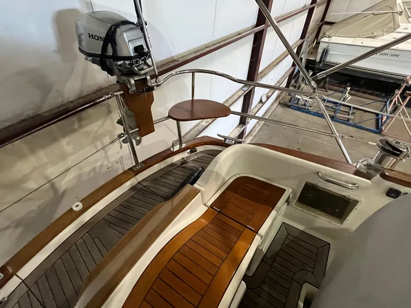 Slide: The Image of 2003 Fantasi 44 Pilot House boat interior with wooden deck and Honda motor. - 21