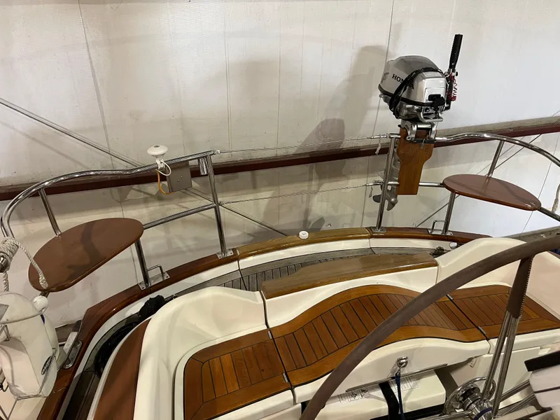 Slide: The Image of Fantasi 44 Pilot House 2003 boat interior with wooden seating and mounted motor. - 22