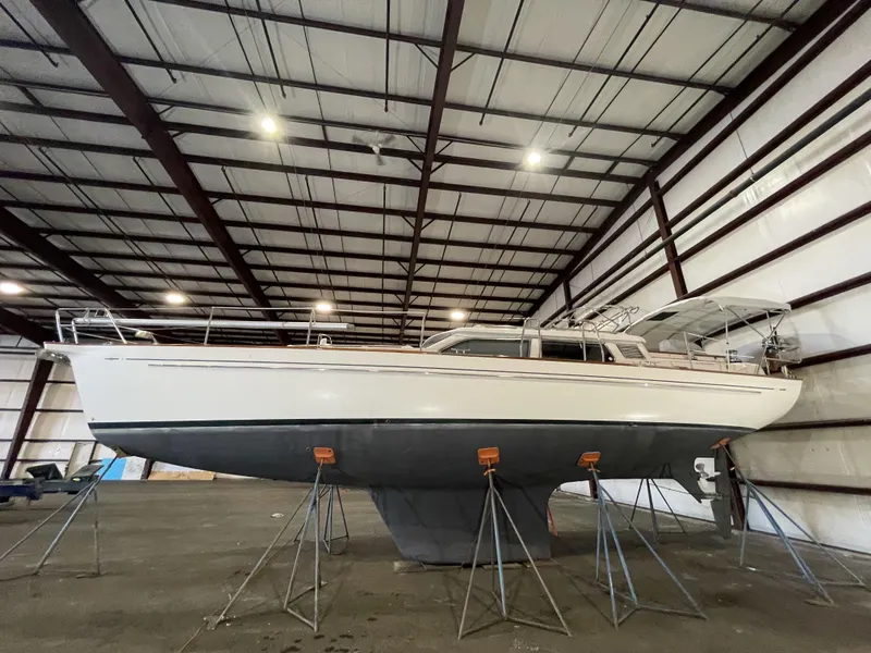 Slide: The Image of 2003 Fantasi 44 Pilot House sailboat in indoor storage on stands. - 3
