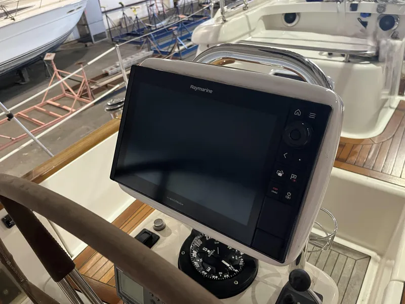 Slide: The Image of Steering console of 2003 Fantasi 44 Pilot House with navigation display and compass. - 30