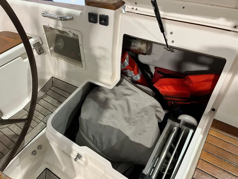Slide: The Image of Storage compartment on 2003 Fantasi 44 Pilot House yacht with life jackets and equipment. - 31