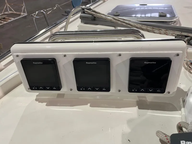 Slide: The Image of Three Raymarine displays on a 2003 Fantasi 44 Pilot House yacht dashboard. - 33