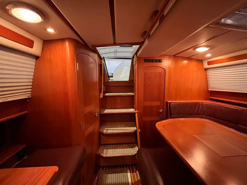 Slide: The Image of Luxurious interior of 2003 Fantasi 44 Pilot House yacht with wooden finishes and seating area. - 39
