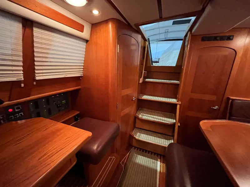 Slide: The Image of Interior of 2003 Fantasi 44 Pilot House yacht with wooden finishes and stairs. - 41