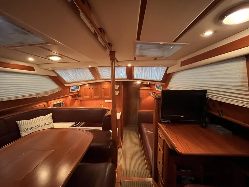 Slide: The Image of Luxurious interior of 2003 Fantasi 44 Pilot House yacht with wood finishes and cozy seating. - 42
