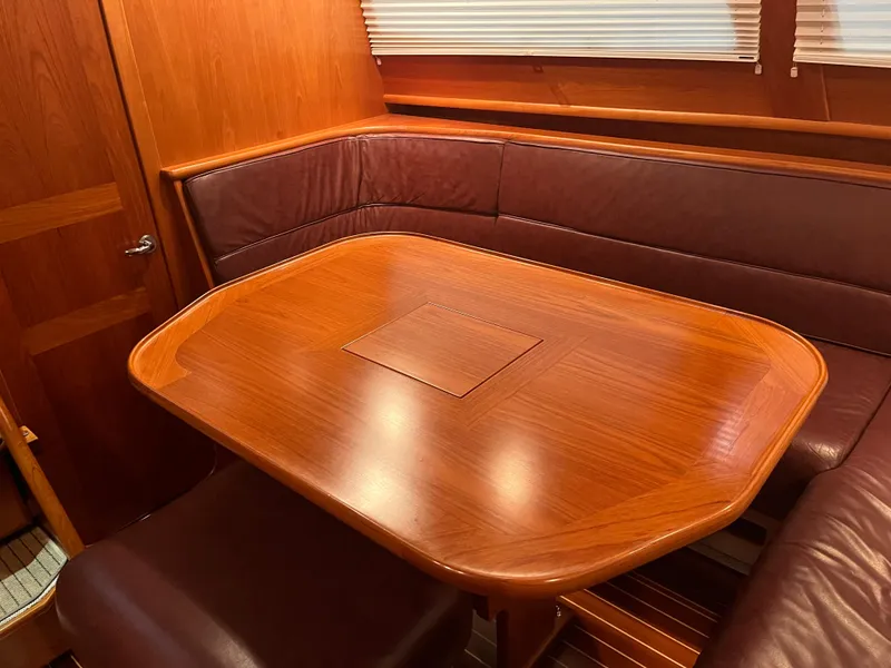 Slide: The Image of Luxurious wood-finished dining area in 2003 Fantasi 44 Pilot House yacht. - 48