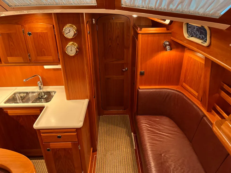 Slide: The Image of Interior of 2003 Fantasi 44 Pilot House yacht with wooden cabinetry and leather seating. - 49