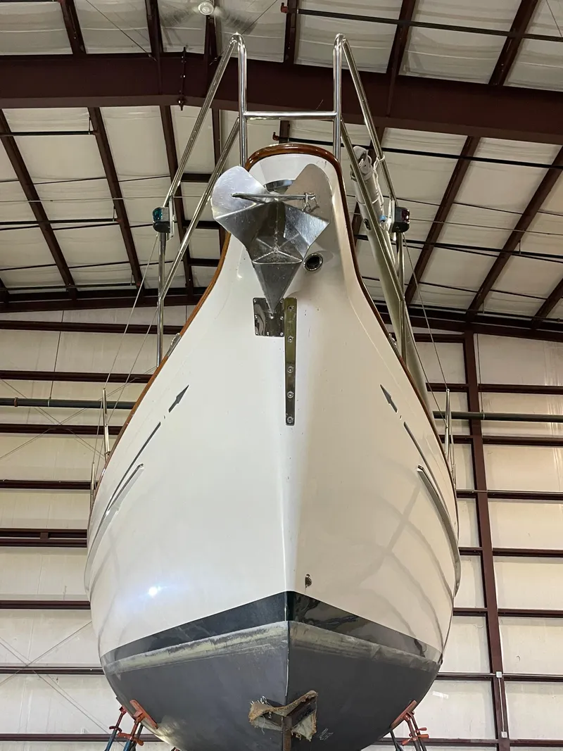 Slide: The Image of 2003 Fantasi 44 Pilot House sailboat in indoor storage, viewed from the bow. - 9