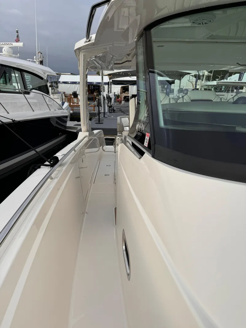 Slide: The Image of 2023 Tiara Yachts 38 LS luxury boat docked at marina. - 11
