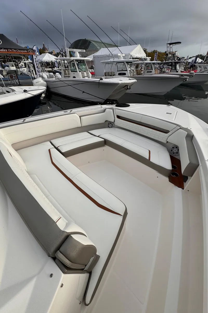 Slide: The Image of 2023 Tiara Yachts 38 LS luxury boat interior with spacious seating at a marina. - 12