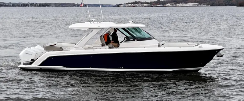 Slide: The Image of 2023 Tiara Yachts 38 LS cruising on a calm lake. - 2