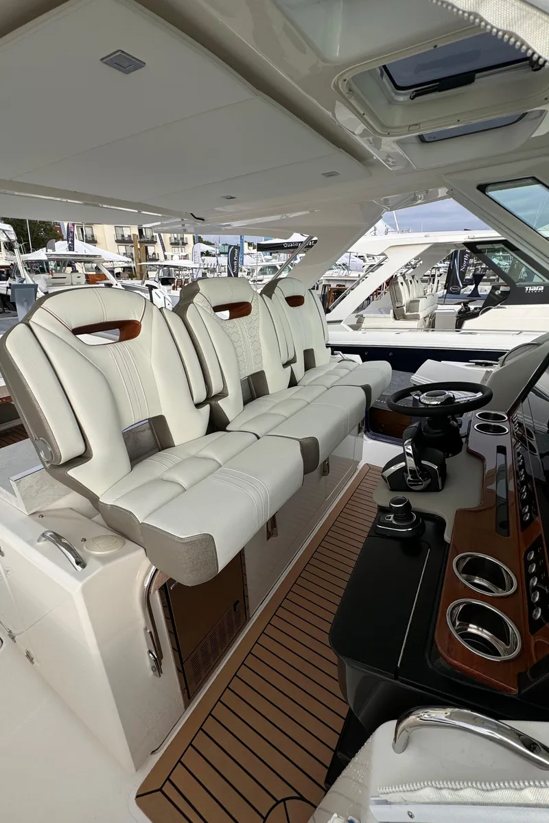 Slide: The Image of 2023 Tiara Yachts 38 LS interior with luxurious seating and modern dashboard. - 9