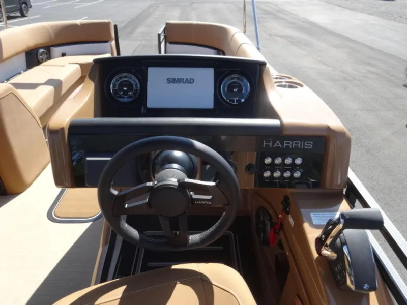 Slide: The Image of 2025 Harris Solstice 250 boat dashboard with steering wheel and control panel. - 10