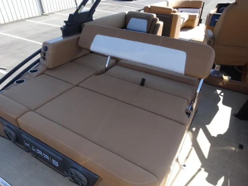 Slide: The Image of 2025 Harris Solstice 250 boat interior with tan seating and cup holders. - 12